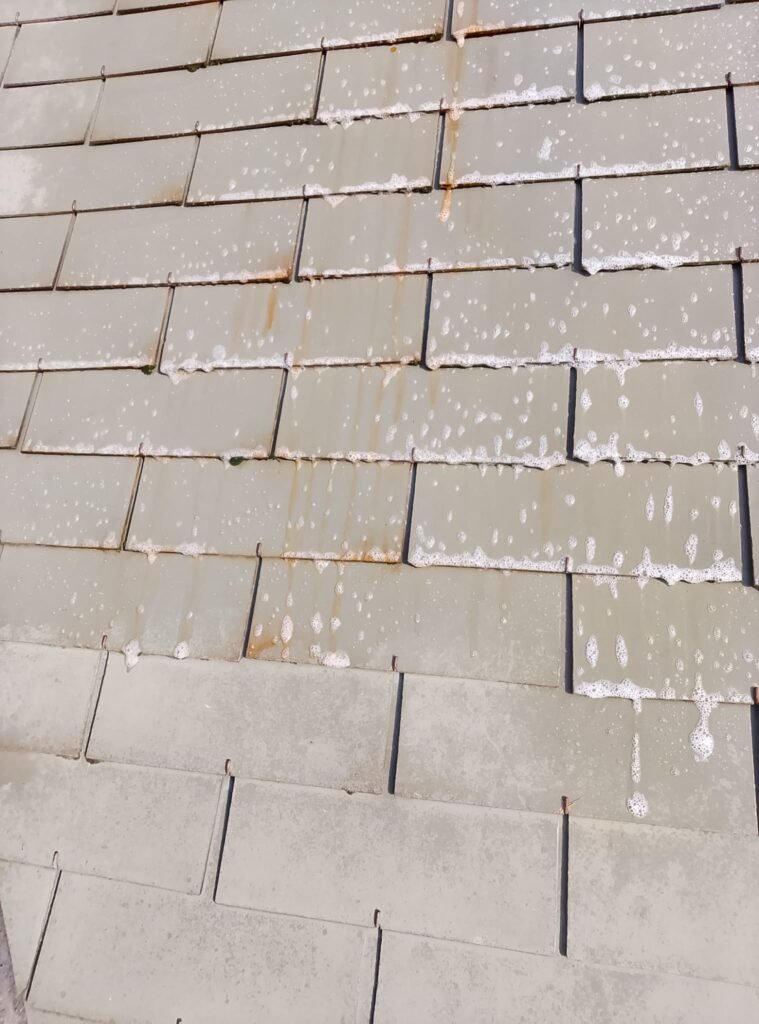 Vue aérienne d'une maison avec une belle toiture propre dans le paysage du Pays de Gex